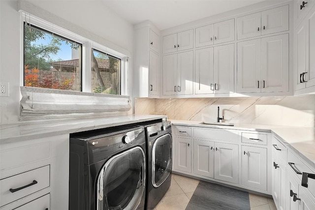 1508 Mesa Ridge Ln, Austin, TX 78735 - laundry room featuring washing machine and clothes dryer, cabinet space, and light tile patterned floors
