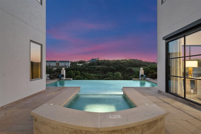 1508 Mesa Ridge Ln, Austin, TX 78735 - pool at dusk with an in-ground hot tub, an outdoor pool, and a patio