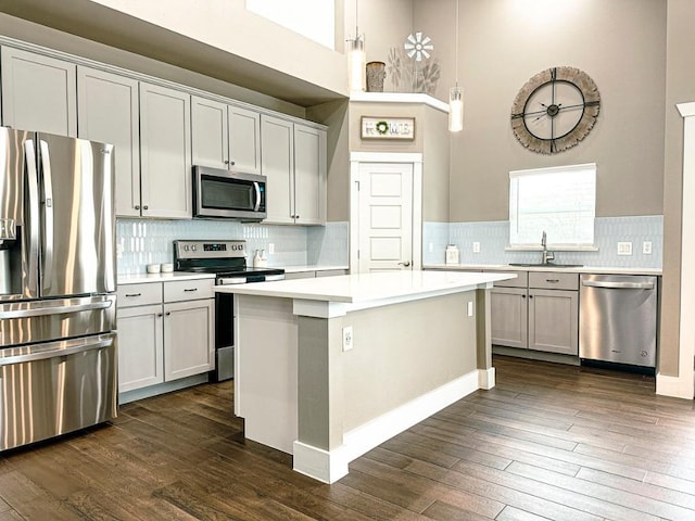 177 Mokulua Ln, Bastrop, TX 78602 - kitchen with stainless steel appliances, light countertops, dark wood-type flooring, decorative backsplash, and a high ceiling