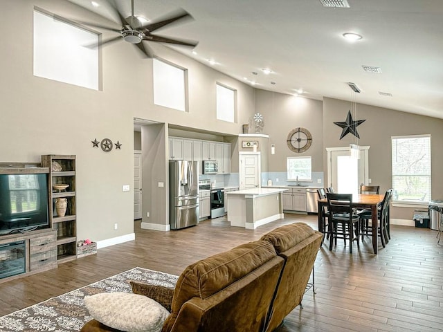 177 Mokulua Ln, Bastrop, TX 78602 - living room with ceiling fan, high vaulted ceiling, wood finished floors, and recessed lighting