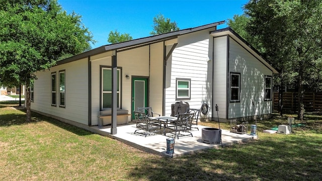 177 Mokulua Ln, Bastrop, TX 78602 - rear view of property featuring a patio area and a lawn