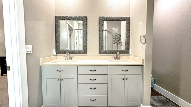 177 Mokulua Ln, Bastrop, TX 78602 - bathroom featuring double vanity and a textured wall