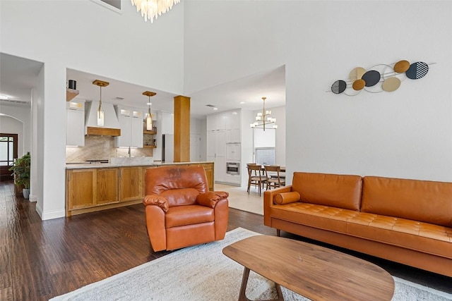 2817 Barefoot Ln, Round Rock, TX 78665 - living room featuring dark wood-style flooring and a chandelier