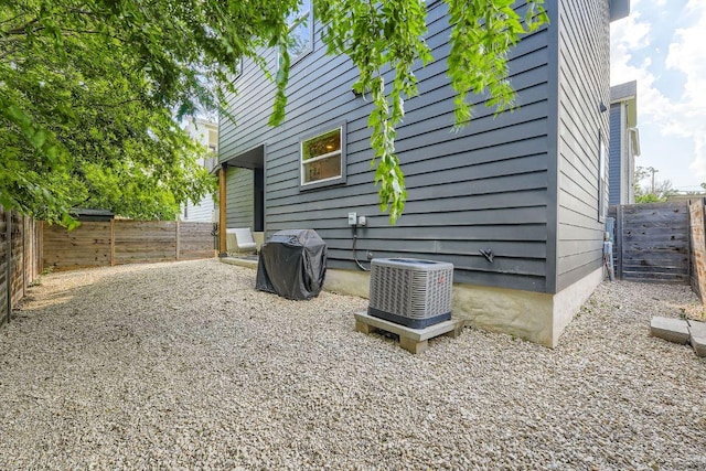 7311 Providence Ave Unit B, Austin, TX 78752 - view of side of home featuring a central AC unit and a fenced backyard