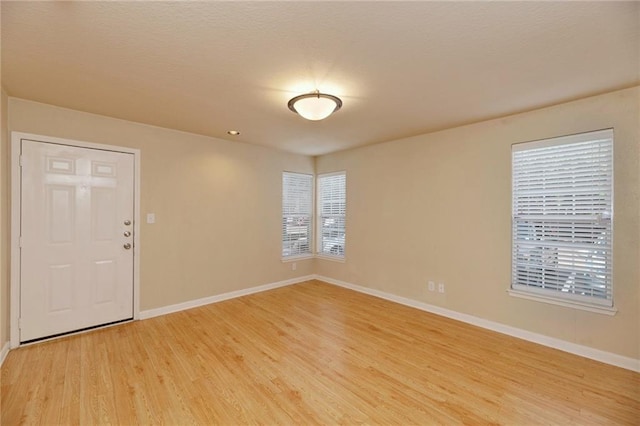 7685 Northcross Dr Unit 605, Austin, TX 78757 - unfurnished room with baseboards and light wood-type flooring