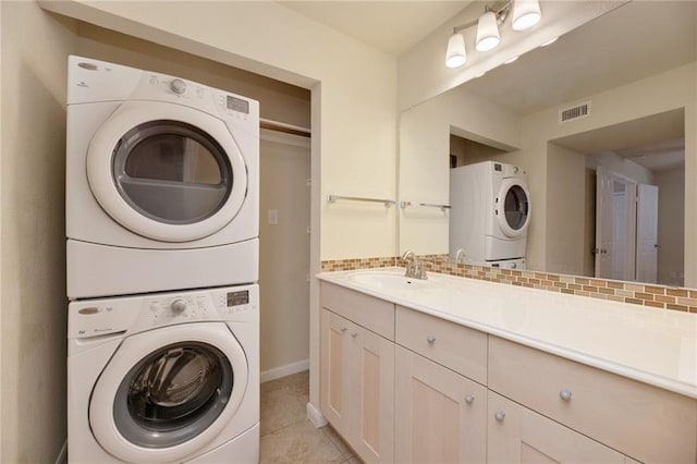 7685 Northcross Dr Unit 605, Austin, TX 78757 - laundry room with stacked washer and clothes dryer and light tile patterned flooring