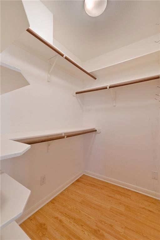 7685 Northcross Dr Unit 605, Austin, TX 78757 - walk in closet featuring light wood-style flooring