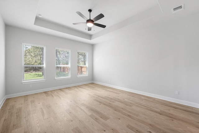 158 Loysoya St, Bastrop, TX 78602 - spare room with a raised ceiling, light wood-style flooring, and a ceiling fan