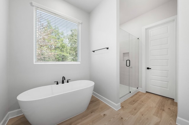 158 Loysoya St, Bastrop, TX 78602 - bathroom featuring a freestanding tub, wood finished floors, and a stall shower