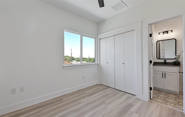 7306 Carver Ave Unit 1, Austin, TX 78752 - unfurnished bedroom with light wood-type flooring, a closet, ensuite bath, and ceiling fan