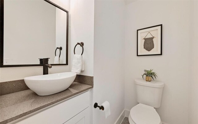 7306 Carver Ave Unit 1, Austin, TX 78752 - half bathroom featuring baseboards and vanity