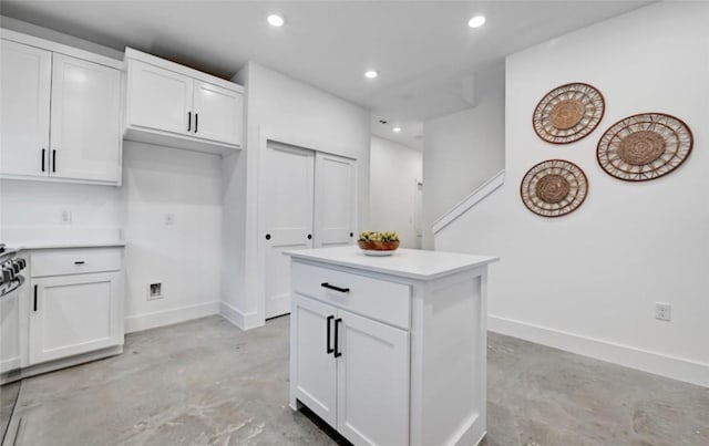 7613 Providence Ave Unit 1, Austin, TX 78752 - kitchen featuring concrete floors, white cabinetry, recessed lighting, light countertops, and a kitchen island