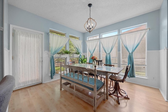 1306 River Oak Dr, Leander, TX 78641 - dining room featuring a chandelier, a textured ceiling, and light wood-type flooring