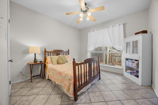 1306 River Oak Dr, Leander, TX 78641 - bedroom featuring light tile patterned floors, a textured ceiling, and ceiling fan