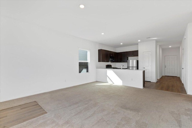 14320 Tordillo Dr, Elgin, TX 78621 - unfurnished living room featuring light carpet and recessed lighting