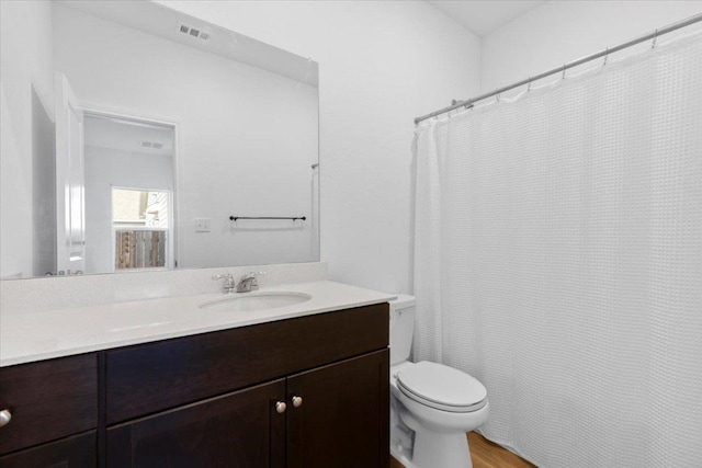 14320 Tordillo Dr, Elgin, TX 78621 - bathroom with vanity, a shower with shower curtain, and wood finished floors