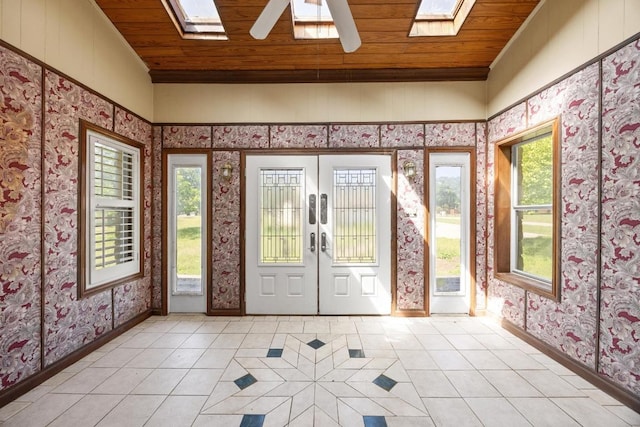 1001 S Gabriel Dr, Leander, TX 78641 - foyer featuring a skylight, wallpapered walls, wood ceiling, light tile patterned floors, and french doors