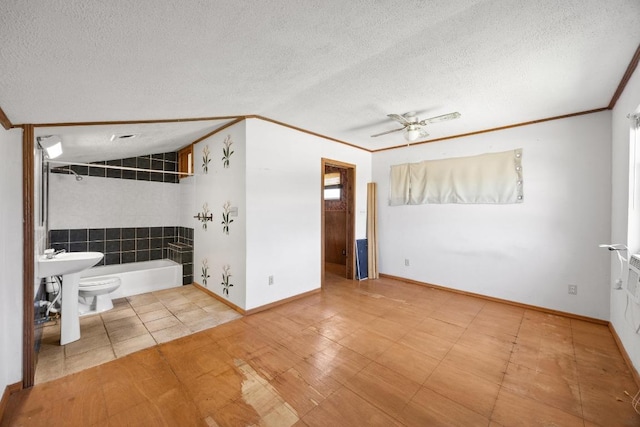 1001 S Gabriel Dr, Leander, TX 78641 - bathroom with a textured ceiling, ornamental molding, a ceiling fan, tile patterned flooring, and vaulted ceiling