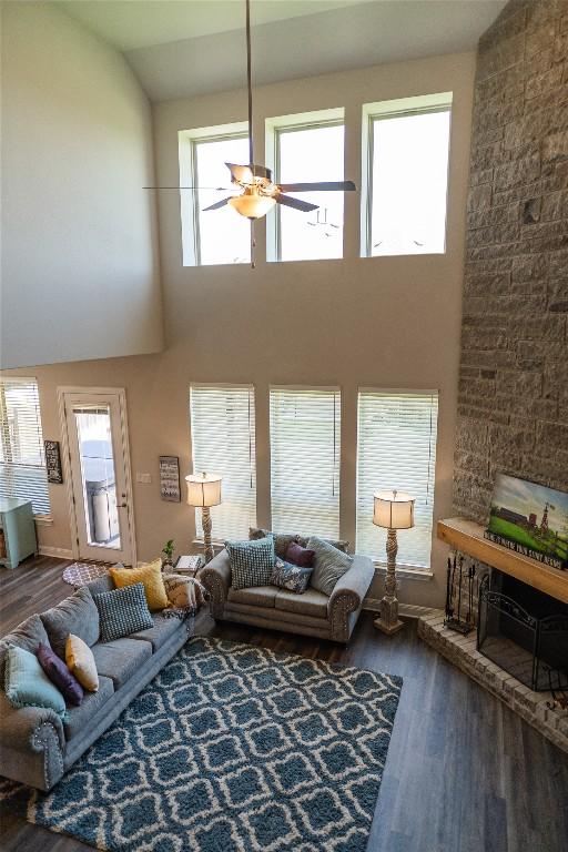 2616 Pine Branch Rd, Leander, TX 78641 - living room featuring wood finished floors, a ceiling fan, a high ceiling, and healthy amount of natural light