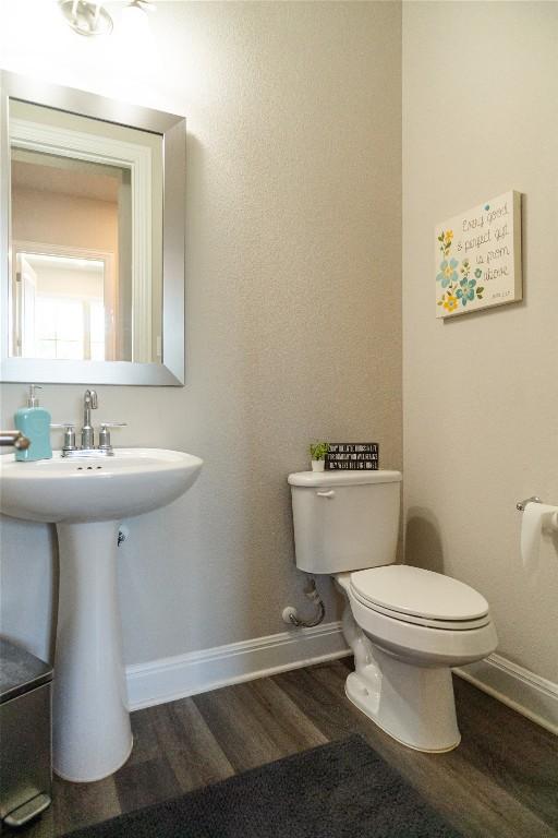 2616 Pine Branch Rd, Leander, TX 78641 - half bathroom featuring toilet and wood finished floors
