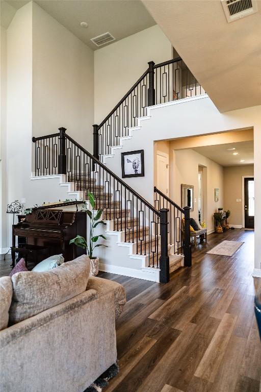 2616 Pine Branch Rd, Leander, TX 78641 - stairway with a towering ceiling and wood finished floors