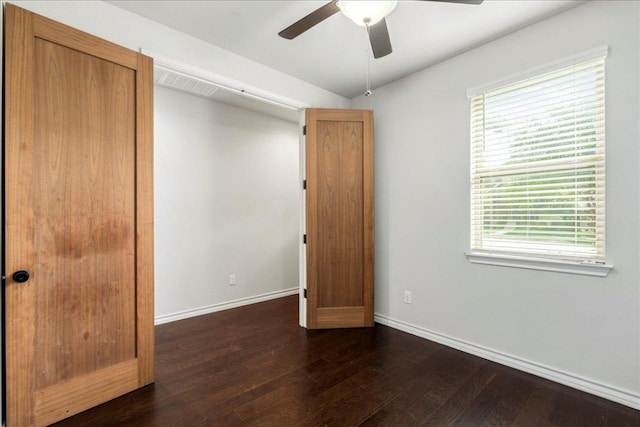 1629 W Broade St, Leander, TX 78641 - unfurnished bedroom featuring dark wood-type flooring, multiple windows, and ceiling fan