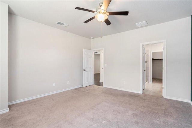 1629 W Broade St, Leander, TX 78641 - unfurnished bedroom featuring light colored carpet, a spacious closet, and a ceiling fan