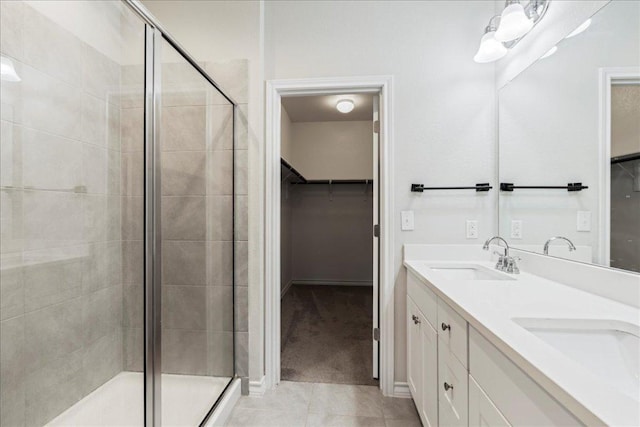 1629 W Broade St, Leander, TX 78641 - full bathroom featuring a spacious closet, a shower stall, double vanity, and tile patterned floors