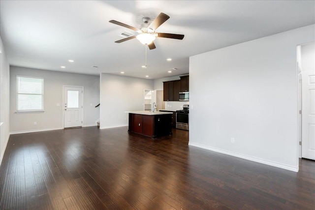 1629 W Broade St, Leander, TX 78641 - unfurnished living room featuring a ceiling fan, dark wood finished floors, stairway, and recessed lighting
