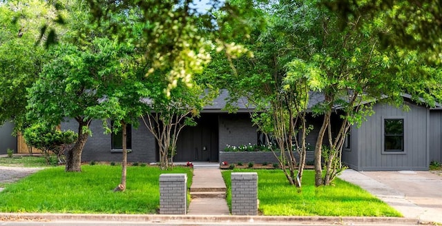2105 Brunswick, Austin, TX 78723 - obstructed view of property with a front lawn and brick siding