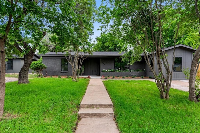 2105 Brunswick, Austin, TX 78723 - mid-century inspired home with a front yard, brick siding, and board and batten siding