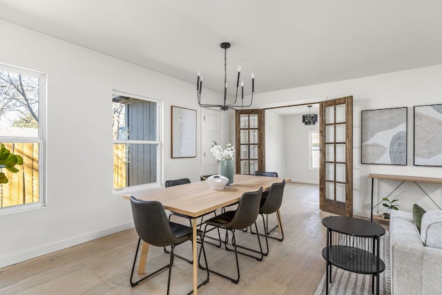 2105 Brunswick, Austin, TX 78723 - dining room featuring a chandelier and light wood-style flooring