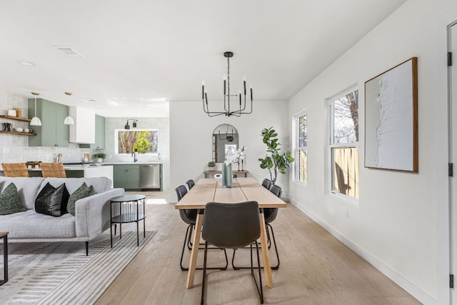 2105 Brunswick, Austin, TX 78723 - dining area featuring a chandelier, healthy amount of natural light, and light wood-style flooring