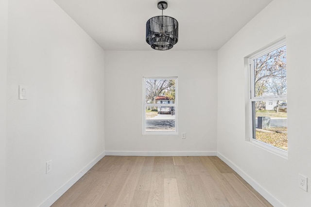 2105 Brunswick, Austin, TX 78723 - unfurnished room featuring light wood-type flooring, plenty of natural light, and a chandelier