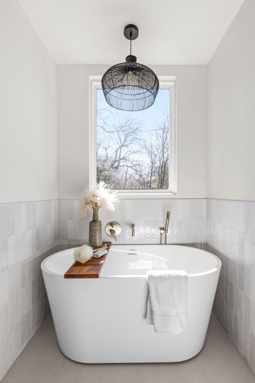 2105 Brunswick, Austin, TX 78723 - full bath with tile walls, a freestanding bath, plenty of natural light, and wainscoting