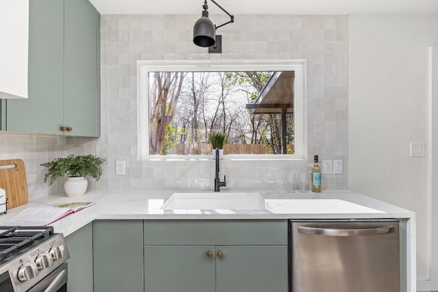 2105 Brunswick, Austin, TX 78723 - kitchen featuring stainless steel appliances, green cabinetry, and tasteful backsplash