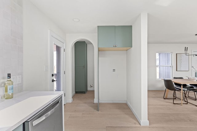 2105 Brunswick, Austin, TX 78723 - kitchen featuring dishwasher, light wood-style flooring, light countertops, and arched walkways