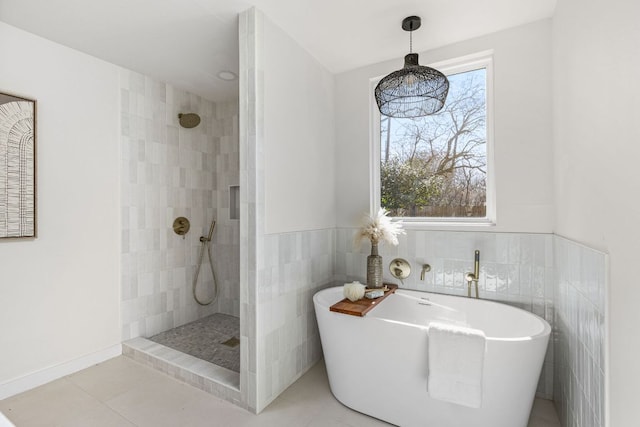 2105 Brunswick, Austin, TX 78723 - bathroom featuring a walk in shower, a freestanding tub, tile patterned flooring, tile walls, and a wainscoted wall
