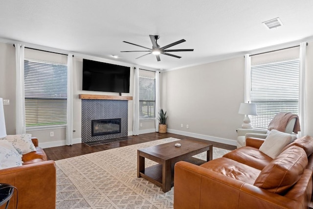 104 Hazeltine Dr, Georgetown, TX 78628 - living area with ceiling fan, plenty of natural light, wood finished floors, and a fireplace
