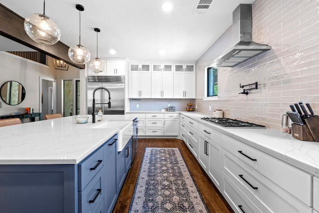 104 Hazeltine Dr, Georgetown, TX 78628 - kitchen with wall chimney exhaust hood, gas cooktop, stainless steel built in fridge, tasteful backsplash, and white cabinets