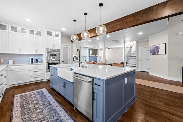 104 Hazeltine Dr, Georgetown, TX 78628 - kitchen featuring stainless steel appliances, white cabinetry, glass insert cabinets, backsplash, and recessed lighting