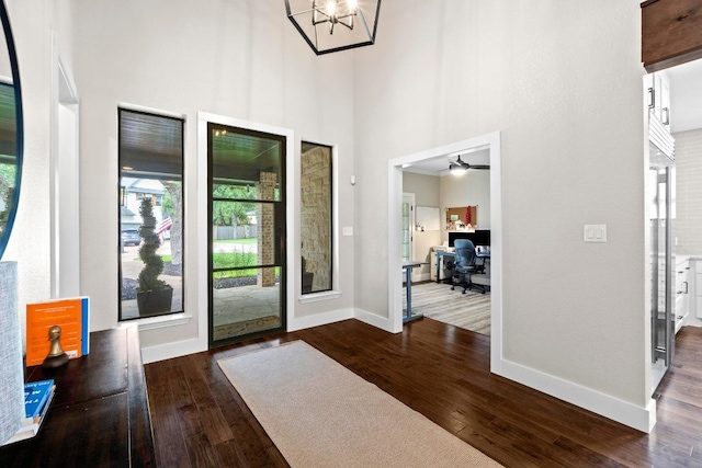 104 Hazeltine Dr, Georgetown, TX 78628 - foyer featuring dark wood finished floors, a high ceiling, a chandelier, and ceiling fan