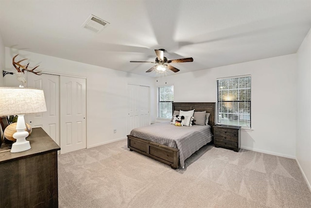 104 Hazeltine Dr, Georgetown, TX 78628 - bedroom featuring multiple closets, light colored carpet, and a ceiling fan