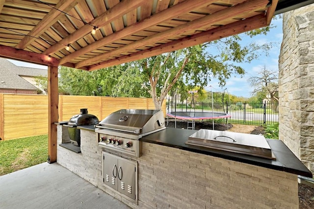 104 Hazeltine Dr, Georgetown, TX 78628 - fenced backyard with area for grilling, a trampoline, and a patio area