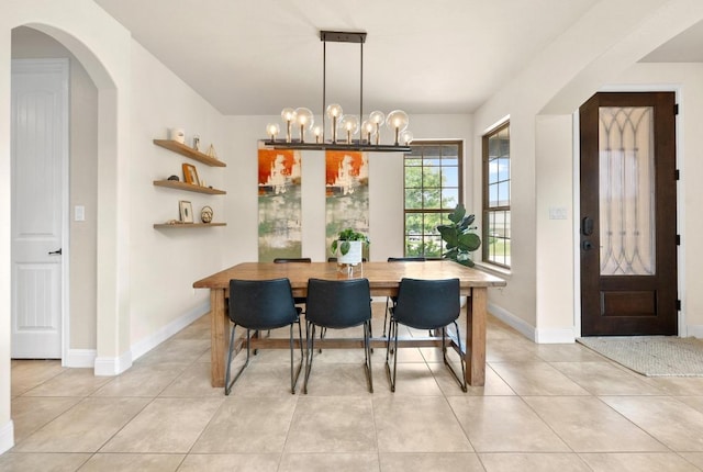 106 Tonkawa Trl W, Austin, TX 78738 - dining area with a chandelier, light tile patterned floors, and arched walkways