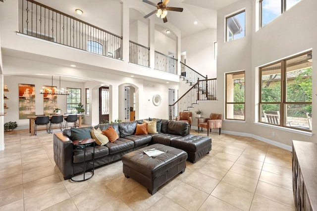 106 Tonkawa Trl W, Austin, TX 78738 - living room with a towering ceiling, light tile patterned floors, ceiling fan, arched walkways, and stairs