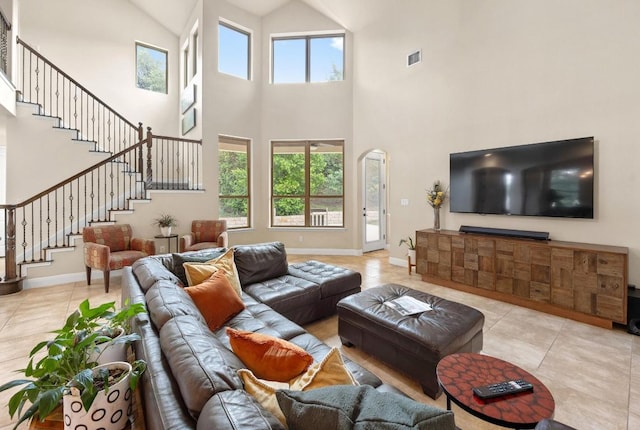 106 Tonkawa Trl W, Austin, TX 78738 - living area with light tile patterned floors, high vaulted ceiling, stairway, and arched walkways