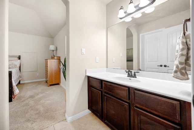 106 Tonkawa Trl W, Austin, TX 78738 - bathroom with vanity, vaulted ceiling, and tile patterned floors
