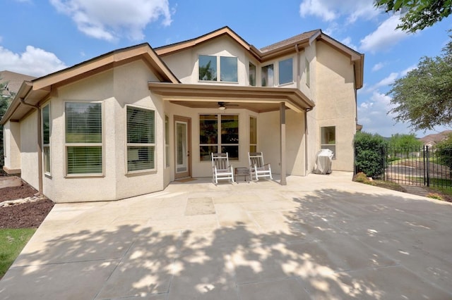 106 Tonkawa Trl W, Austin, TX 78738 - rear view of property featuring stucco siding, ceiling fan, and a patio