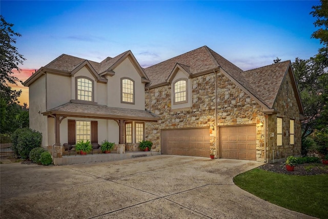 106 Tonkawa Trl W, Austin, TX 78738 - french country inspired facade featuring concrete driveway, stone siding, stucco siding, and covered porch